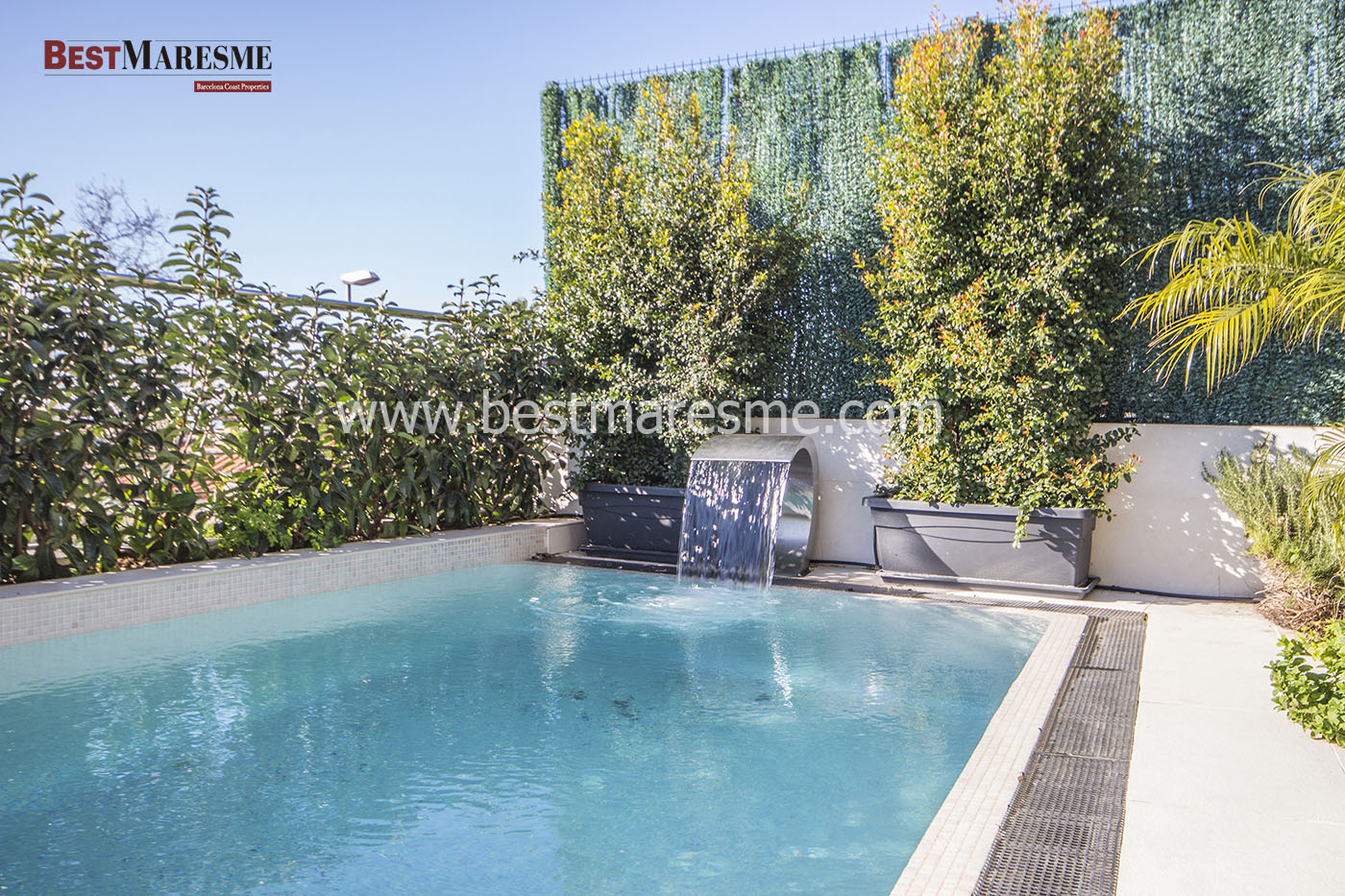 Piscina salina con cascada desbordante iluminada con cromoterapia